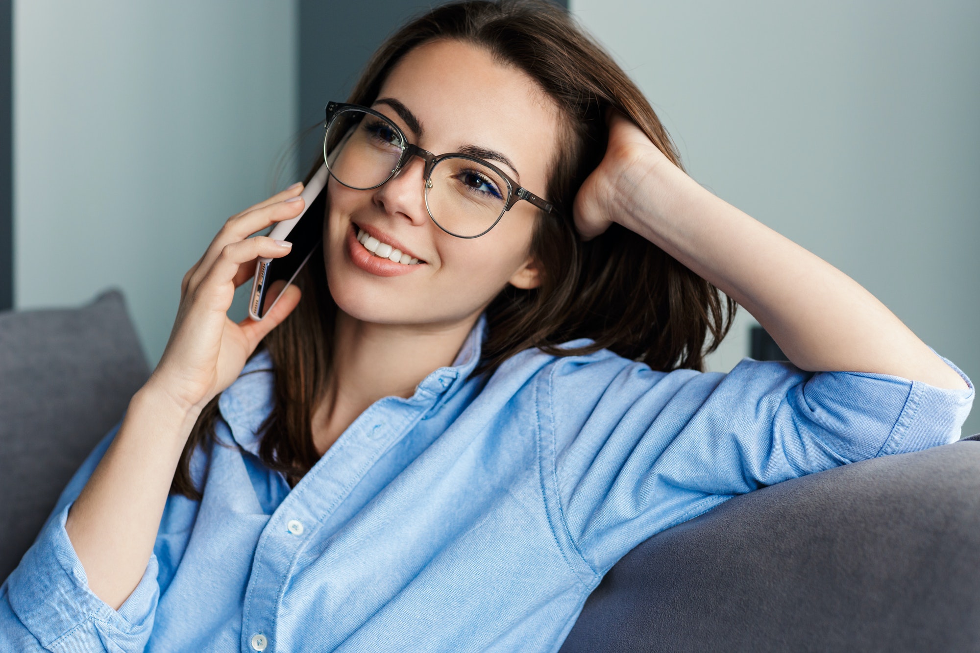 Image of woman talking on cellphone and smiling while sitting
